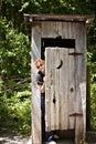 Outhouse with woman peeking out Royalty Free Stock Photo