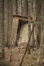 Outhouse in the woods Royalty Free Stock Photo