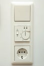 Outlet with an electrical socket, outlets and thermostat for underfloor heating