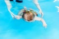 The outline of a child floating under water