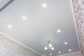 An outline of a stretch ceiling in a room with a chandelier and spotlights Royalty Free Stock Photo