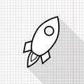 Outlined rocket icon on a copybook page