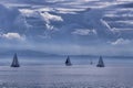 The outlines of mountains, rare silhouettes of sailboats are visible on the horizon