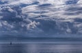 The outlines of mountains, rare silhouettes of sailboats are visible on the horizon