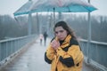 Outoor picture of young woman with umbrella