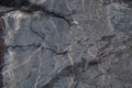 The output of dark shale rock with veins, natural stone background. Royalty Free Stock Photo