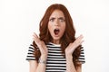 Outraged upset angry redhead girl in striped t-shirt, wristwatch furrow eyebrows, open mouth ambushed and frustrated Royalty Free Stock Photo