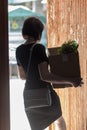 An outraged woman with a box in her hand after being