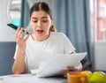 Outraged woman with documents in her hands talking on mobile phone