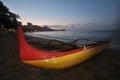 An outrigger canoe sits on the beach Royalty Free Stock Photo