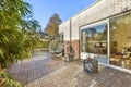 a backyard with a brick patio and a glass door Royalty Free Stock Photo