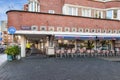 the outside of a building with tables and chairs