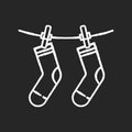 Outside drying chalk white icon on black background. Laundry, outdoors clothes drying. Socks hanging on clothesline Royalty Free Stock Photo