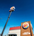 Outside a fast-food Burger King restaurant with a sleek, contemporary futuristic industrial look includes brick cladding