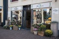 Outside of flower florist shop store showing entrance, window display, sign and branding