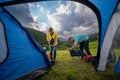 Outside my tent. Setting up a camp for a night. Couple man and woman Installation of portable chairs and a table, beautiful