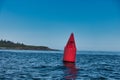 Outside nature photo featuring red ocean buoy for sail boats Royalty Free Stock Photo