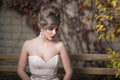 Outside portrait of a beautiful bride with wedding makeup and hairstyle, gorgeous young woman in white dress Royalty Free Stock Photo