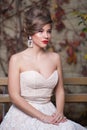 Outside portrait of a beautiful bride with wedding makeup and hairstyle, gorgeous young woman in white dress Royalty Free Stock Photo