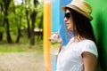 Outside portrait of pretty woman with lemonade or fresh cup in sunglasses and hat Royalty Free Stock Photo