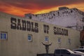 The outside of the Saddle Up Saloon with cars and trucks in the parking lot with powerful red clouds at sunset in downtown Mobile Royalty Free Stock Photo