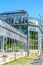 Outside of steamy conservatory greenhouse under blue sky with moon Royalty Free Stock Photo