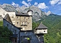 Outside view of Castle Hohenwerfen, Austria with wall, towers, gatehouse and the peaks of the Tennen range in the Austrian Alps in Royalty Free Stock Photo