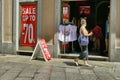 Outside view of clothing store with sale signs