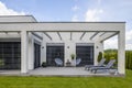 View of elegant suburban house with big window green lawn