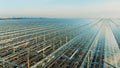 Outside view of greenery units with glasslike ceiling. Greenhouses aerial view, epic view on industrial glasshouse. Royalty Free Stock Photo