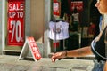 Outside view of clothing store with sale signs