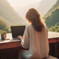 Outside work, a girl works on a laptop with a beautiful landscape.