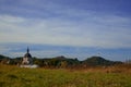 Outskirts meadow with church building and TV tower on background, old and new construction concept picture with empty copy space Royalty Free Stock Photo