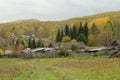 Outskirts of the Parnaya village against the background of the Kuznetsk Alatau mountains in cloudy autumn weather. Krasnoyarsk