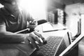 Outsource Developer working on marble Desk Working Laptop Computer Mobile Application Software and digital tablet dock smart