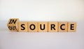 Outsource or insource symbol. Fliped wooden cubes and changed the word `outsource` to `insource`. Beautiful white background,