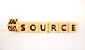 Outsource or insource symbol. Turned a wooden cube and changed the concept word Outsource to Insource. Beautiful white table white