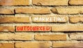 Outsourced marketing symbol. Concept words Outsourced marketing on beautiful brown brick wall. Beautiful brown brick wall