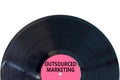 Outsourced marketing symbol. Concept words Outsourced marketing on beautiful black vinyl disk. Beautiful white table white