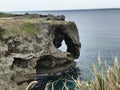 The outstanding cliff and a dazzling view of emerald ocean at Cape Manzamo in Japan. Royalty Free Stock Photo