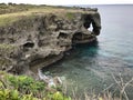 The outstanding cliff and a dazzling view of emerald ocean at Cape Manzamo in Japan. Royalty Free Stock Photo