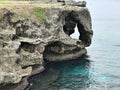 The outstanding cliff and a dazzling view of emerald ocean at Cape Manzamo in Japan. Royalty Free Stock Photo