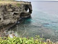 The outstanding cliff and a dazzling view of emerald ocean at Cape Manzamo in Japan. Royalty Free Stock Photo