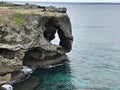 The outstanding cliff and a dazzling view of emerald ocean at Cape Manzamo in Japan. Royalty Free Stock Photo