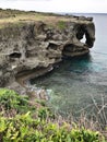 The outstanding cliff and a dazzling view of emerald ocean at Cape Manzamo in Japan. Royalty Free Stock Photo