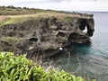 The outstanding cliff and a dazzling view of emerald ocean at Cape Manzamo in Japan. Royalty Free Stock Photo