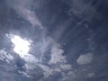 An outstanding snapshot of a special view of a pattern of clusters of dark clouds in blue sky with bright sunlight