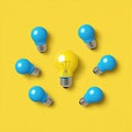 Outstanding Unique Yellow Lightbulb Stands Out Among Blue Lightbulbs With Circular Shape On Yellow Royalty Free Stock Photo