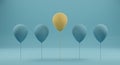 Outstanding yellow balloon among blue balloon on blue background. Royalty Free Stock Photo