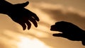 Outstretched hands, salvation, help silhouette, concept help. Rescue, helping gesture or hands. Two hands silhouette on